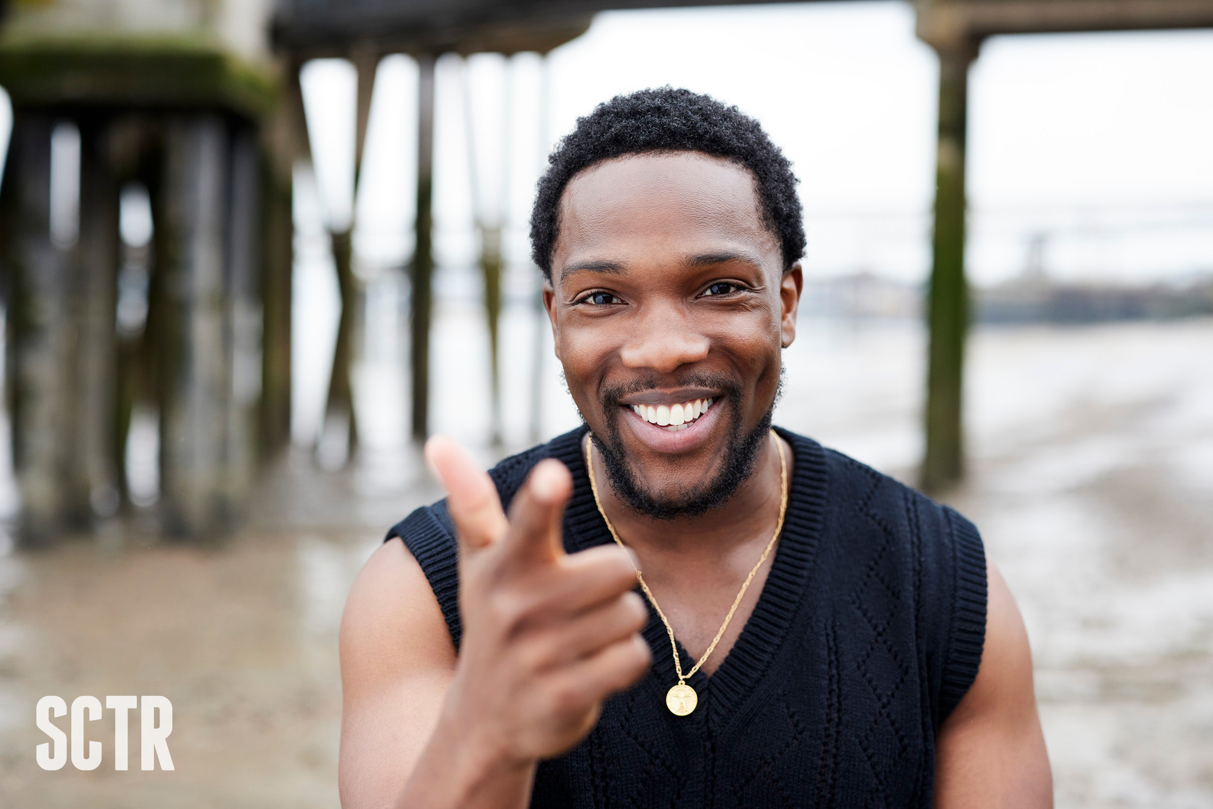 Tosin Cole smiling at the camera