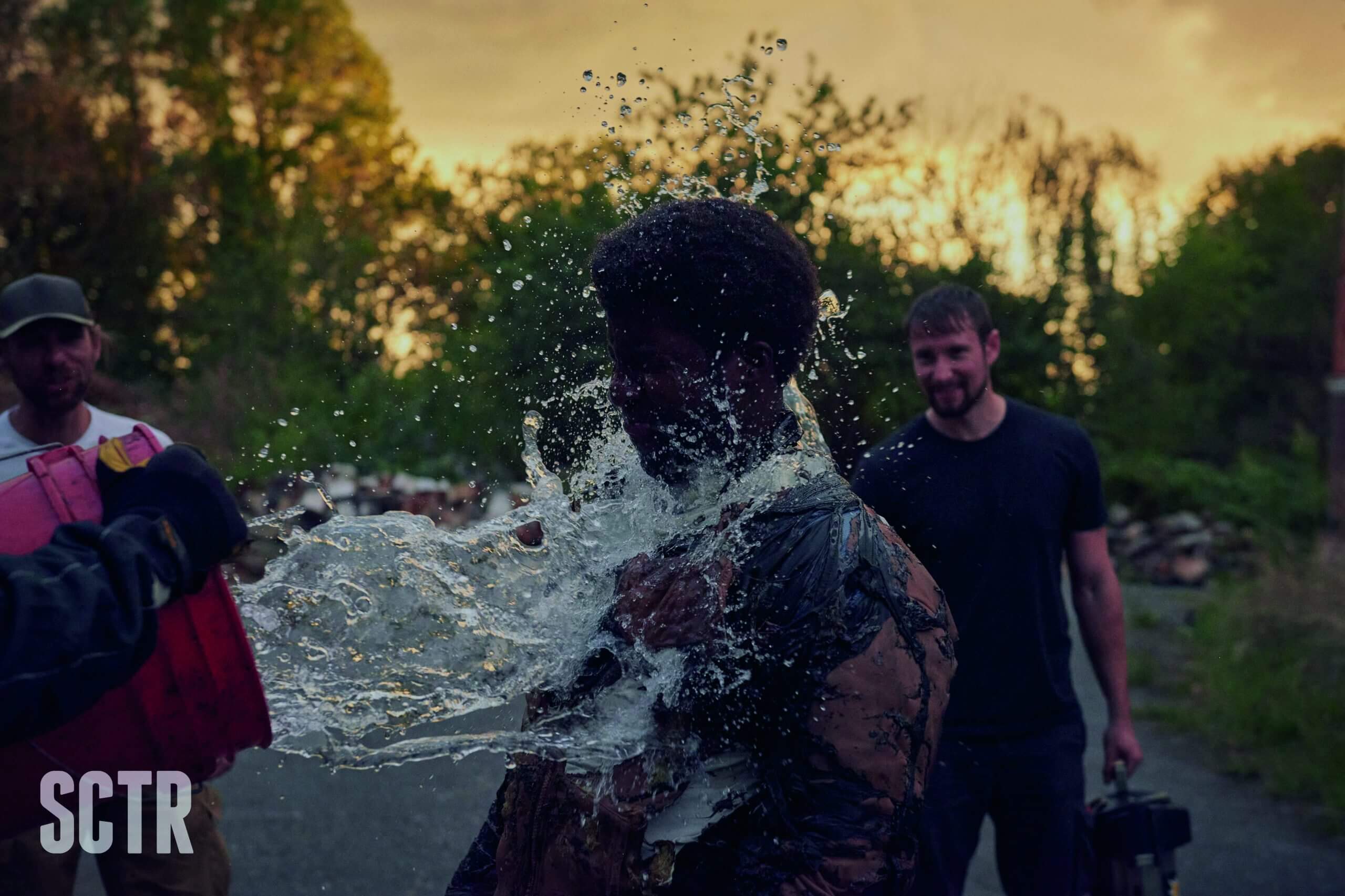 Aidie Palmer being doused with water after performing a stunt involving fire