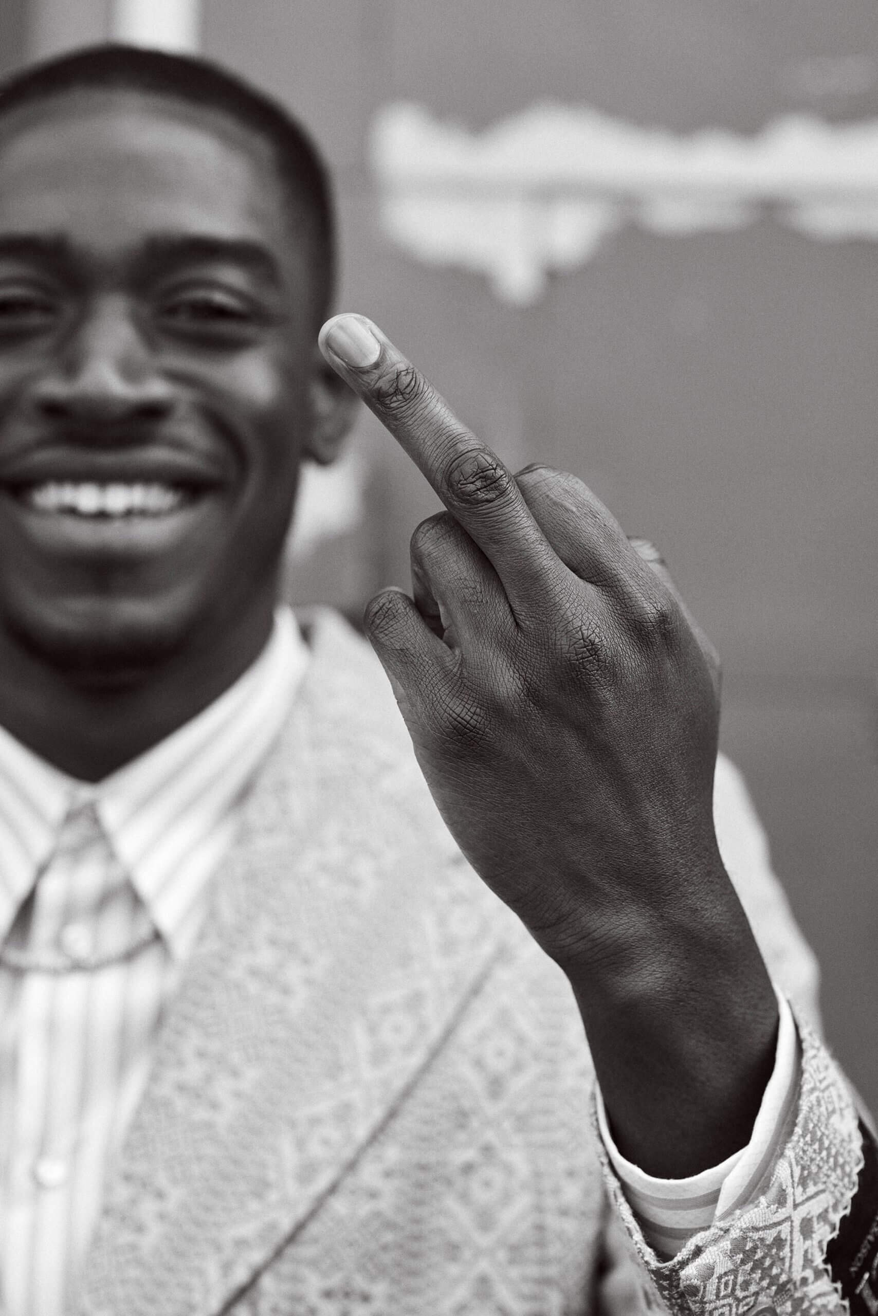 Damson Idris sticking his middle finger up at the camera