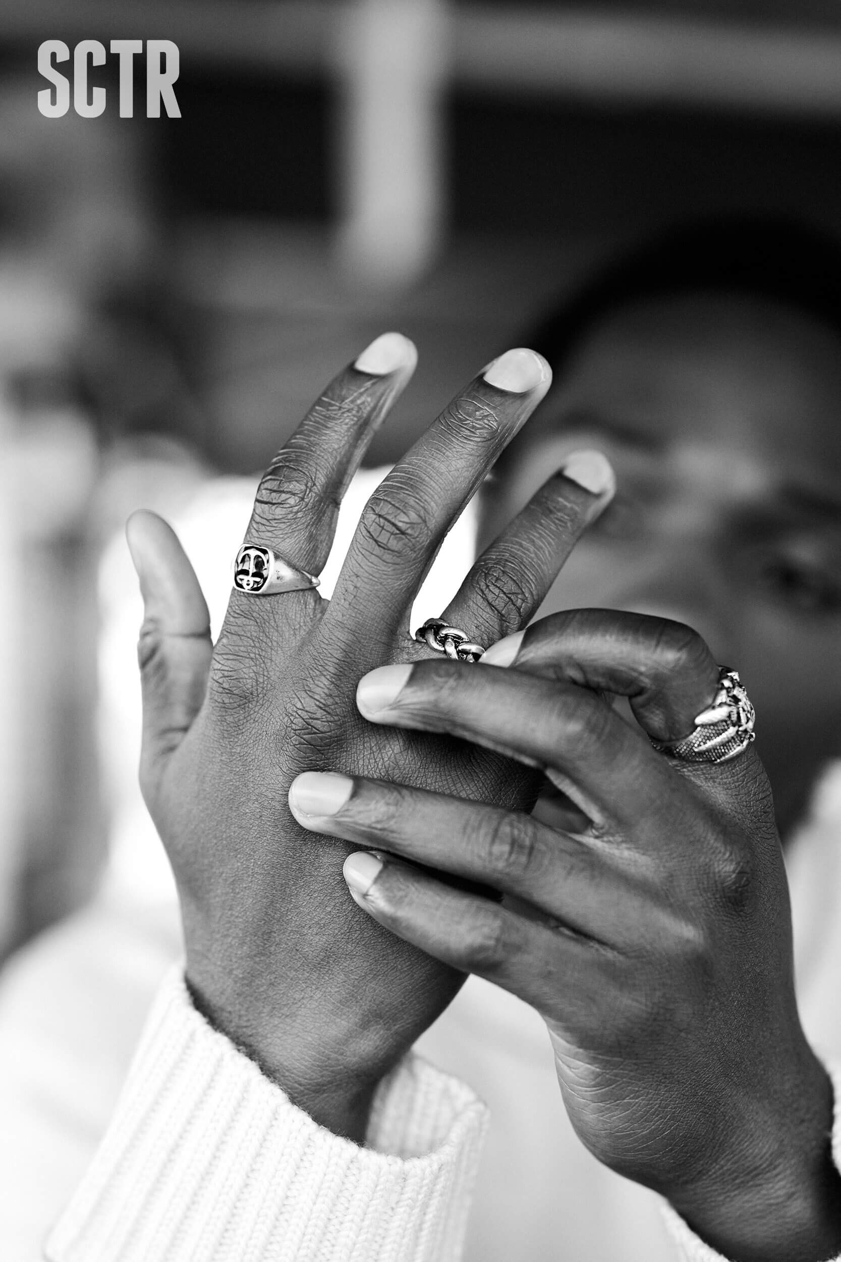 Tosin Cole putting some rings on his fingers